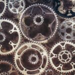 Close-up of interlocking metal gears on a textured background