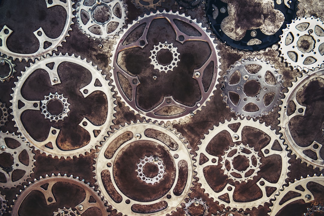 Close-up of interlocking metal gears on a textured background