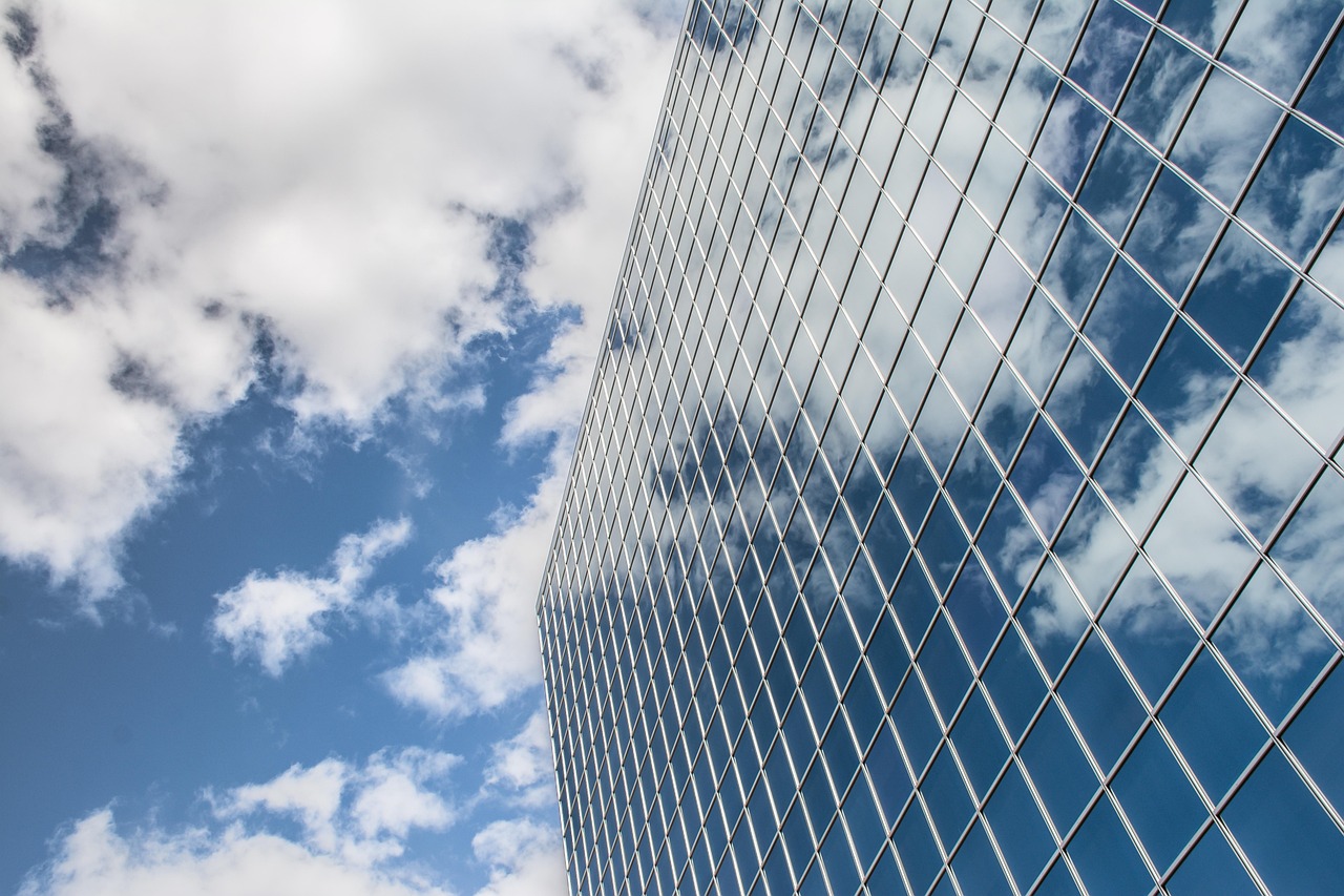 Building, reflection, clouds — Bill Hutchinson: A Global Visionary Shaping Dallas Real Estate and Community